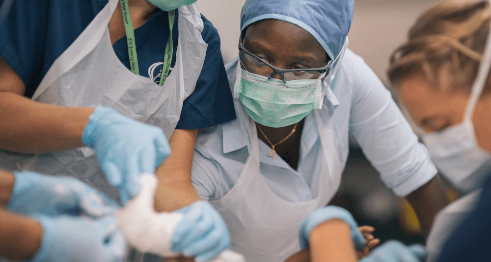 Volunteer surgeons performing surgery